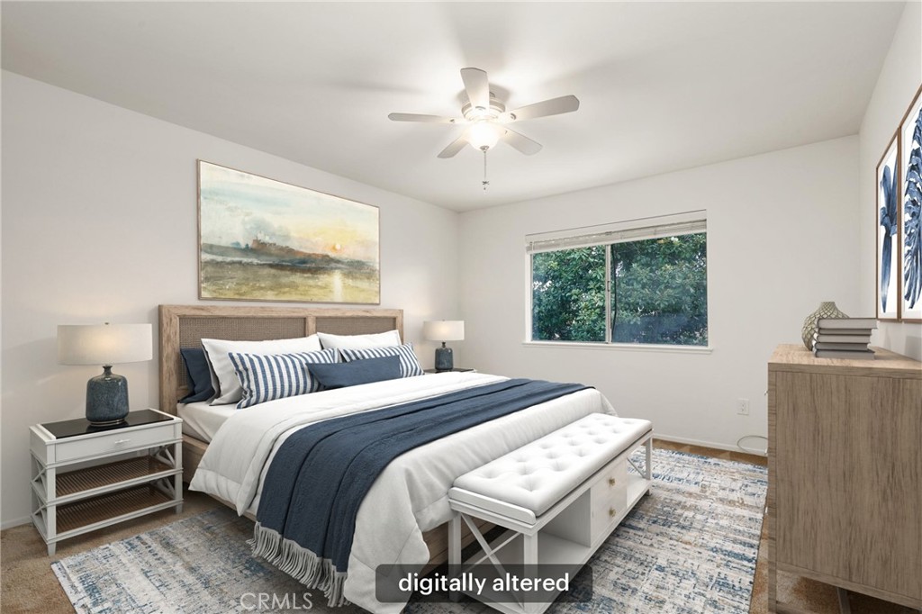 12200 Montecito Road, Unit D301 Seal Beach, CA 90740 - Photo 14 of 32 a bedroom with a bed and a chandelier