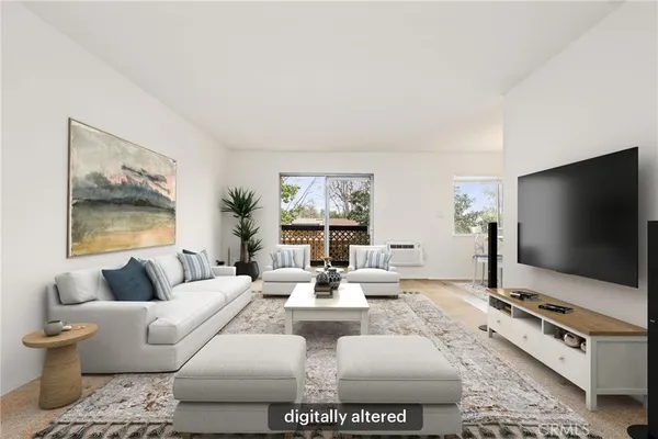 a living room with furniture a flat screen tv and a floor to ceiling window