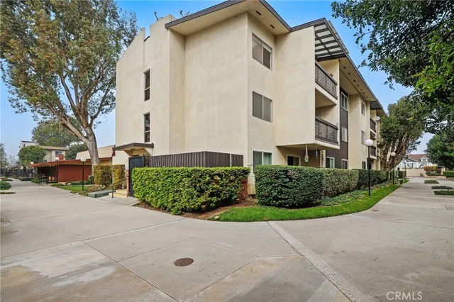 a view of a white house with a street