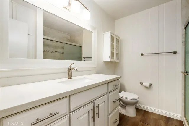 a bathroom with a sink a toilet and mirror