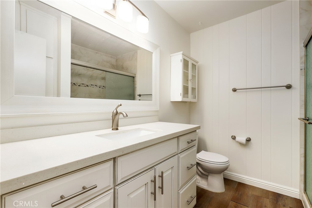 12200 Montecito Road, Unit D301 Seal Beach, CA 90740 - Photo 8 of 32 a bathroom with a sink a toilet and mirror