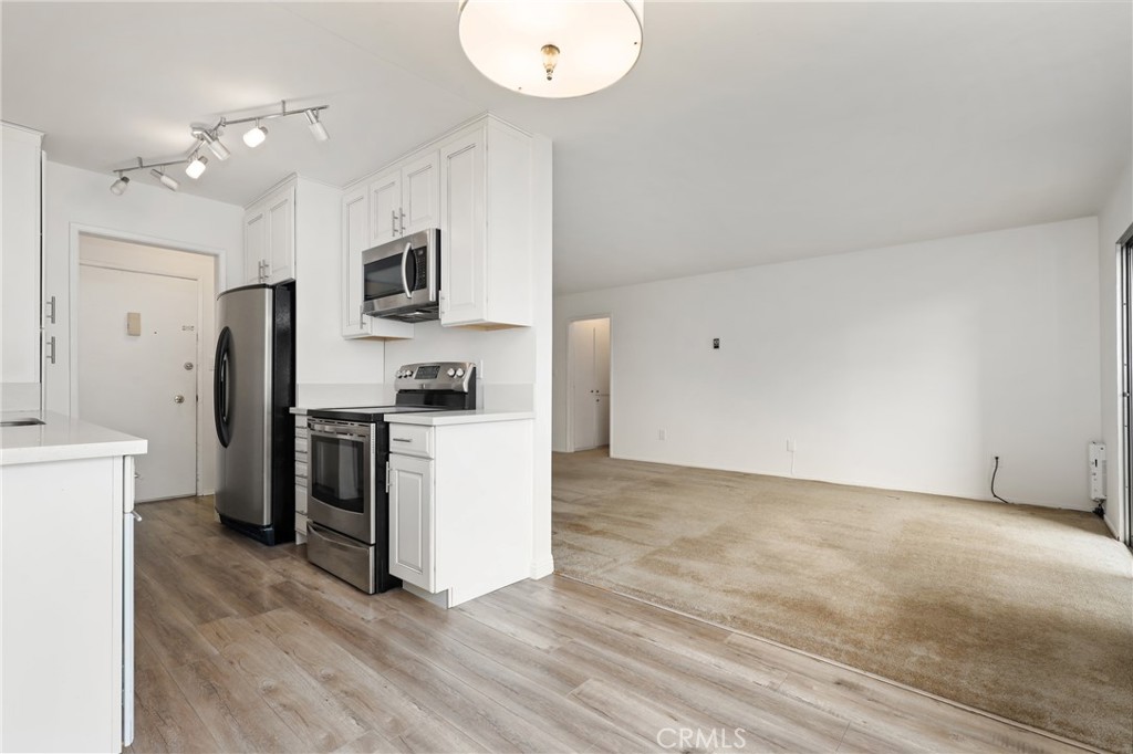 12200 Montecito Road, Unit D301 Seal Beach, CA 90740 - Photo 10 of 32 a kitchen with a refrigerator and a stove top oven