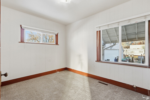 202 Main Street Smithfield, UT 84335 - Photo 15 of 32 Carpeted spare room featuring wooden walls