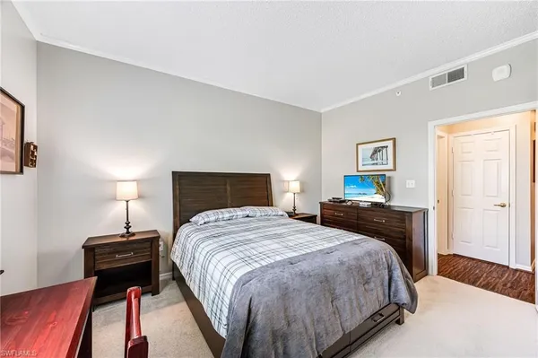 a bedroom with a bed and a lamp