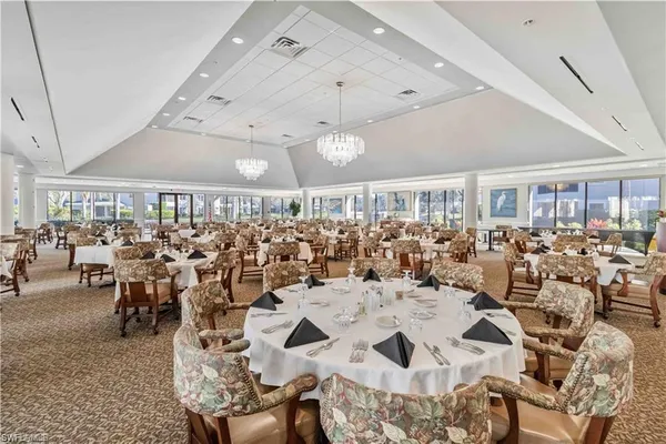 a large room with lots of chairs and chandelier