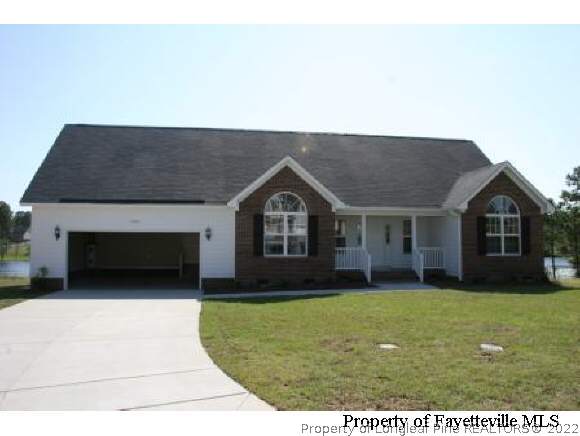 1932 Nuthatch Road Fayetteville, NC 28304 - Photo 1 of 9 a front view of a house with a yard and garage