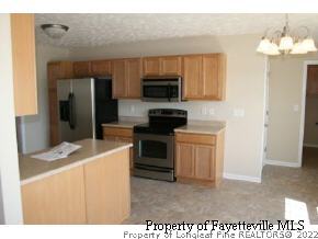 1932 Nuthatch Road Fayetteville, NC 28304 - Photo 3 of 9 a kitchen with a stove and a microwave