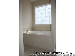 1932 Nuthatch Road Fayetteville, NC 28304 - Photo 8 of 9 a view of bathroom with bathtub and window