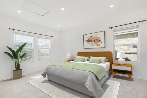 a bedroom with bed and a potted plant