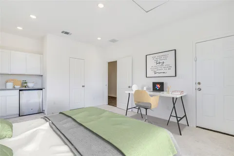 a bedroom with a bed and a chair in it