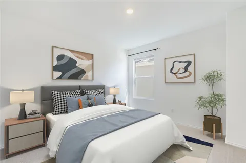 a bedroom with a bed and a painting on the wall