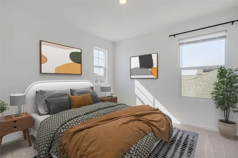 a bedroom with a bed and a potted plant