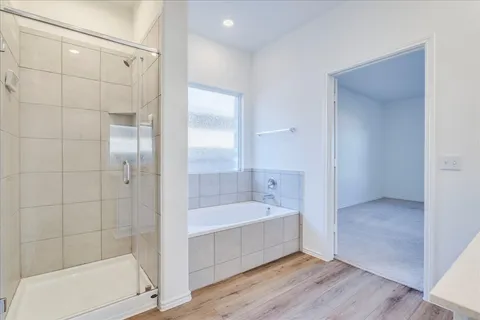 a bathroom with a tub shower and sink