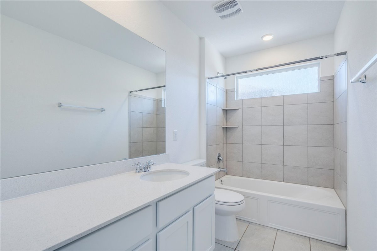 1937 Guntersville Bend Leander, TX 78641 - Photo 33 of 38 a bathroom with a granite countertop sink a toilet and shower