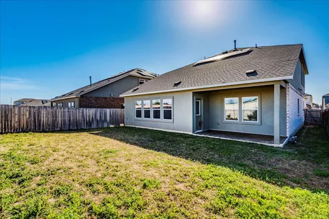 a view of a house with wooden fence