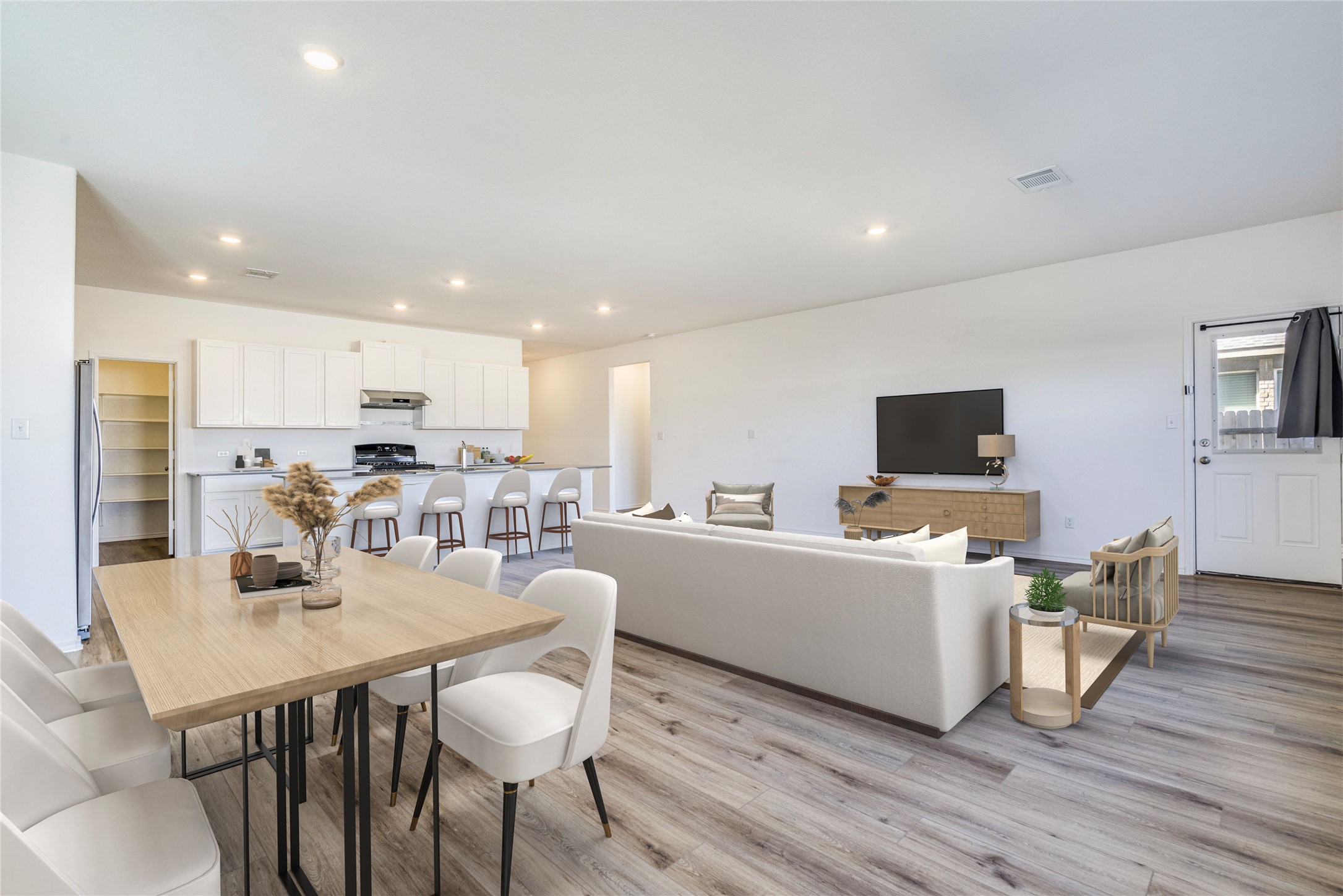1937 Guntersville Bend Leander, TX 78641 - Photo 4 of 38 a kitchen with stainless steel appliances kitchen island granite countertop a dining table chairs and granite counter tops