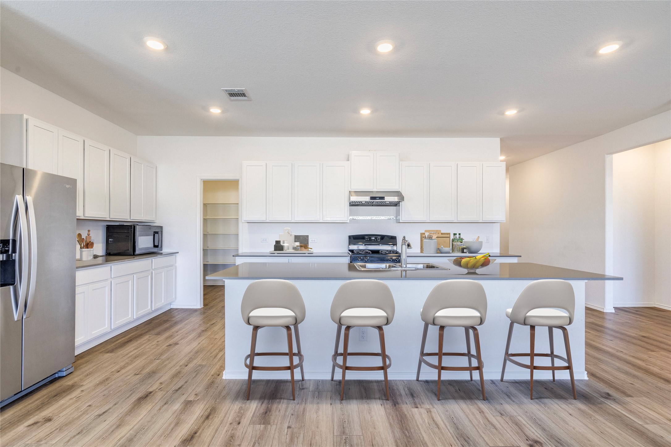 1937 Guntersville Bend Leander, TX 78641 - Photo 6 of 38 a kitchen with stainless steel appliances a microwave a stove a sink a refrigerator and cabinets