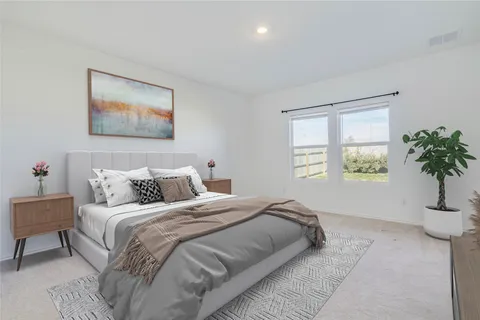 a bedroom with bed and a potted plant