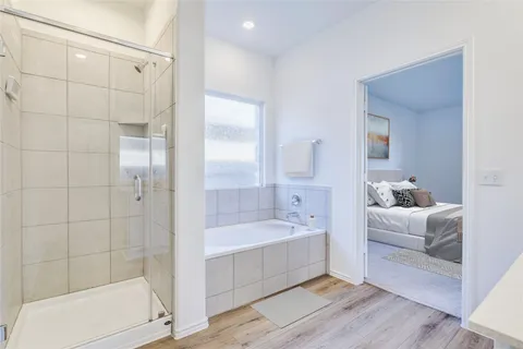 a bathroom with a tub a sink and mirror