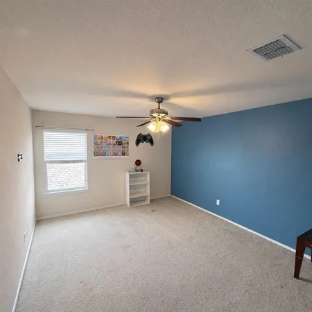 a view of a room with windows and ceiling fan
