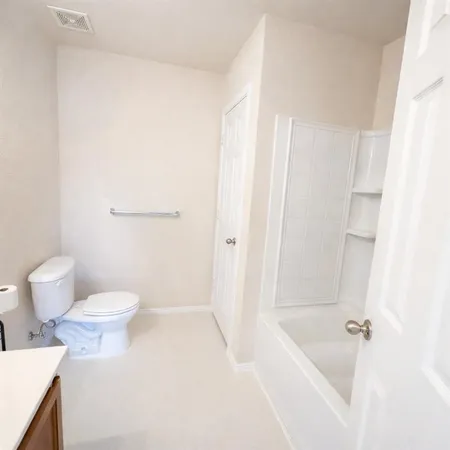 a bathroom with a bathtub and a toilet