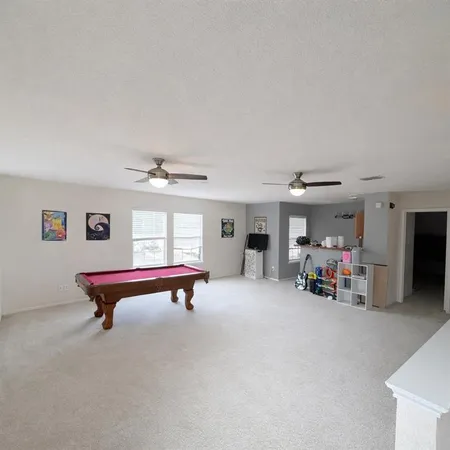 a view of a livingroom with furniture and a ceiling fan
