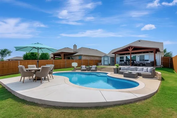 a view of house with swimming pool yard fire pit and outdoor seating