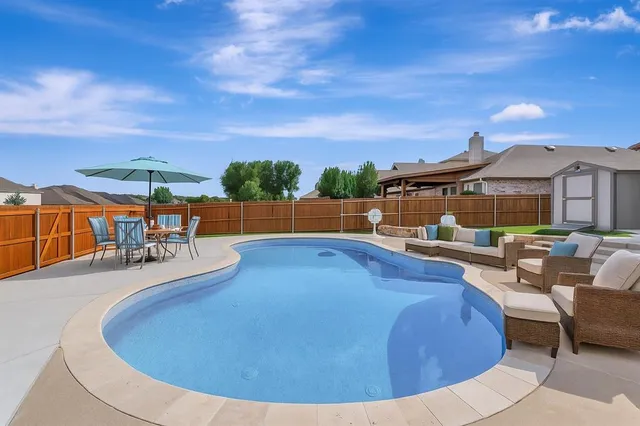 a view of a swimming pool with a patio