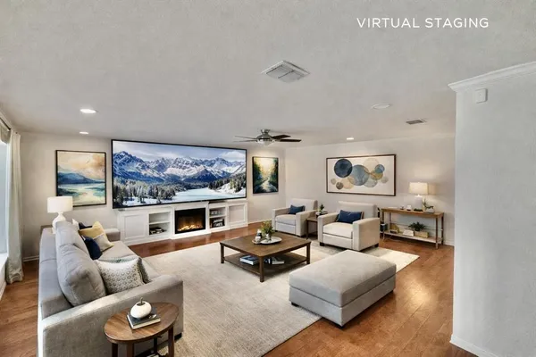 a living room with furniture a fireplace and a flat screen tv
