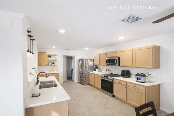 a kitchen with a sink appliances and cabinets