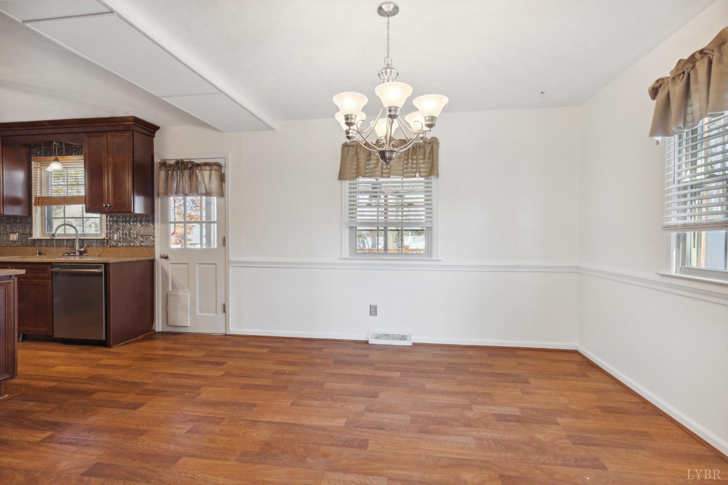 311 Bob Circle Forest, VA 24551 - Photo 13 of 61 a view of kitchen with granite countertop cabinets a sink and a chandelier