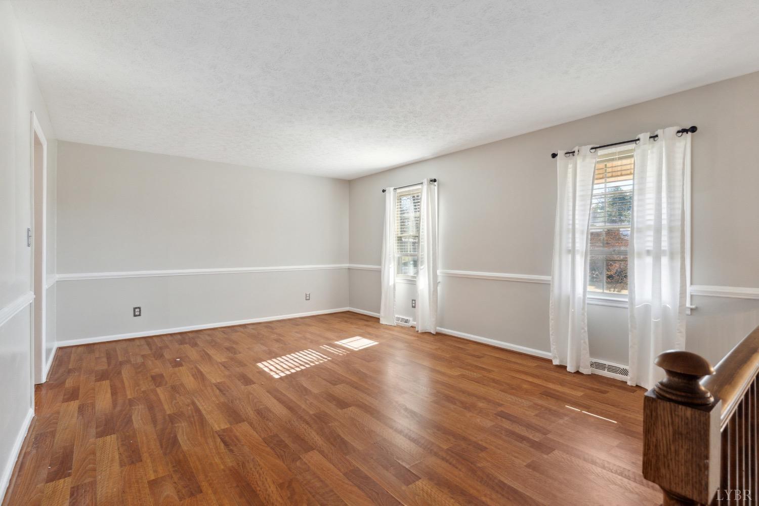 311 Bob Circle Forest, VA 24551 - Photo 14 of 61 a view of an empty room with wooden floor and a window