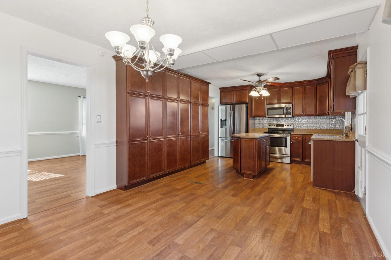 311 Bob Circle Forest, VA 24551 - Photo 16 of 61 a kitchen with stainless steel appliances granite countertop a refrigerator a stove and a wooden floors