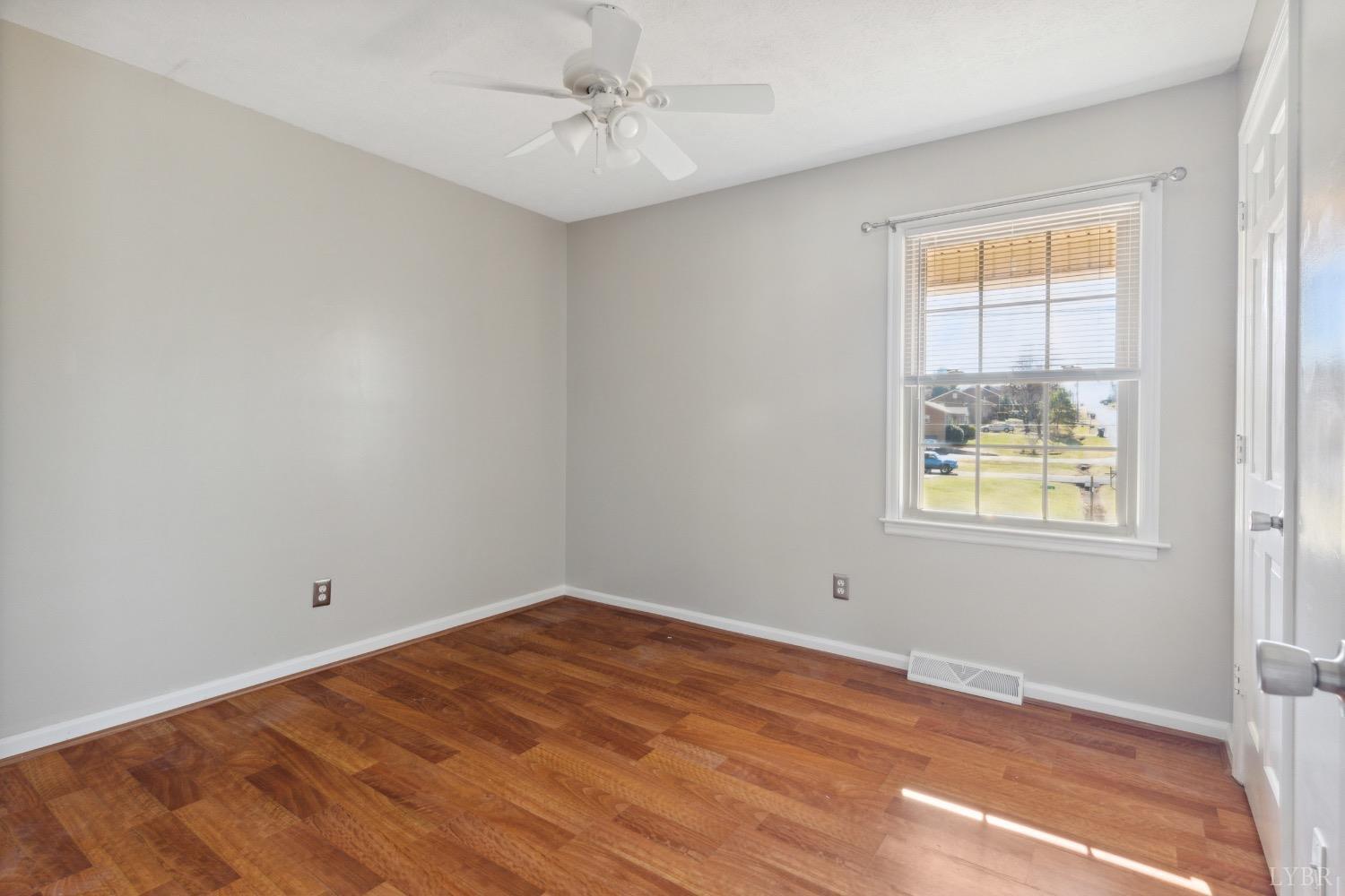 311 Bob Circle Forest, VA 24551 - Photo 22 of 61 a view of empty room with wooden floor and fan