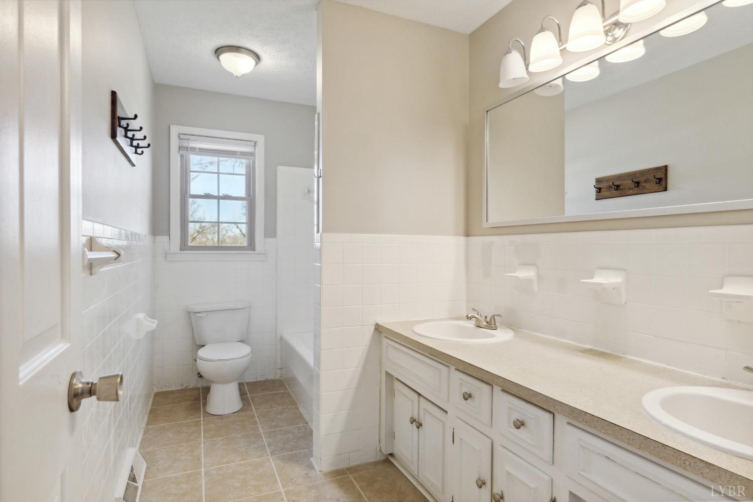 311 Bob Circle Forest, VA 24551 - Photo 27 of 61 a bathroom with a sink a toilet and a mirror