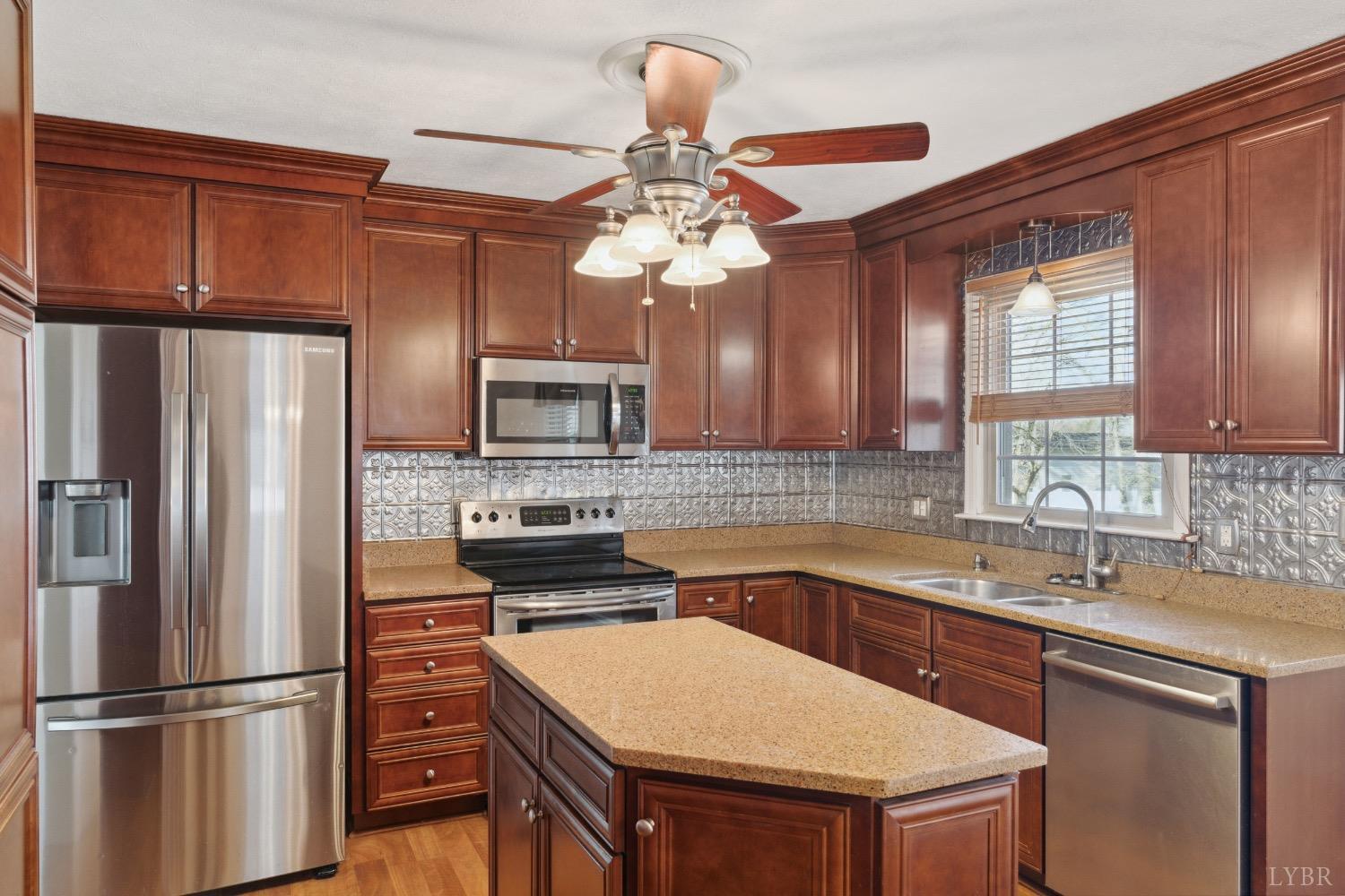 311 Bob Circle Forest, VA 24551 - Photo 38 of 61 a kitchen with stainless steel appliances a sink stove and refrigerator