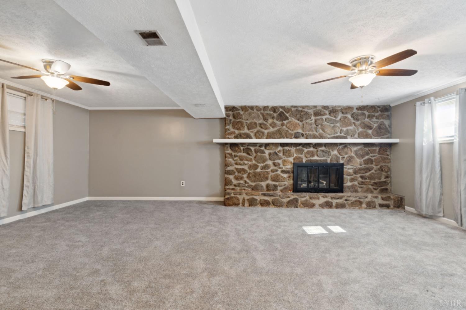 311 Bob Circle Forest, VA 24551 - Photo 53 of 61 en empty room with fireplace and fan