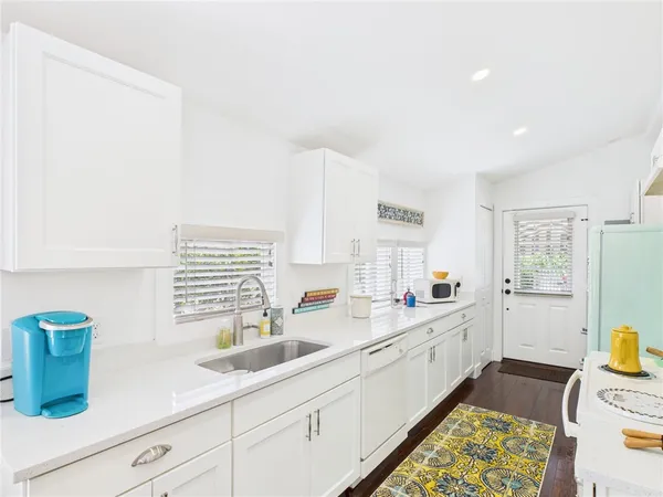 a kitchen with stainless steel appliances granite countertop a sink a refrigerator and a stove