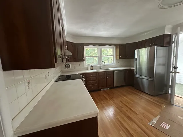 a view of a room with a window and wooden floor