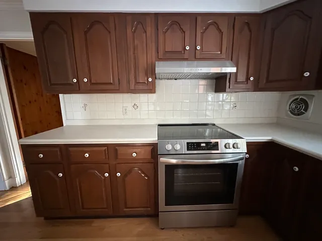 a kitchen with granite countertop a refrigerator and a sink