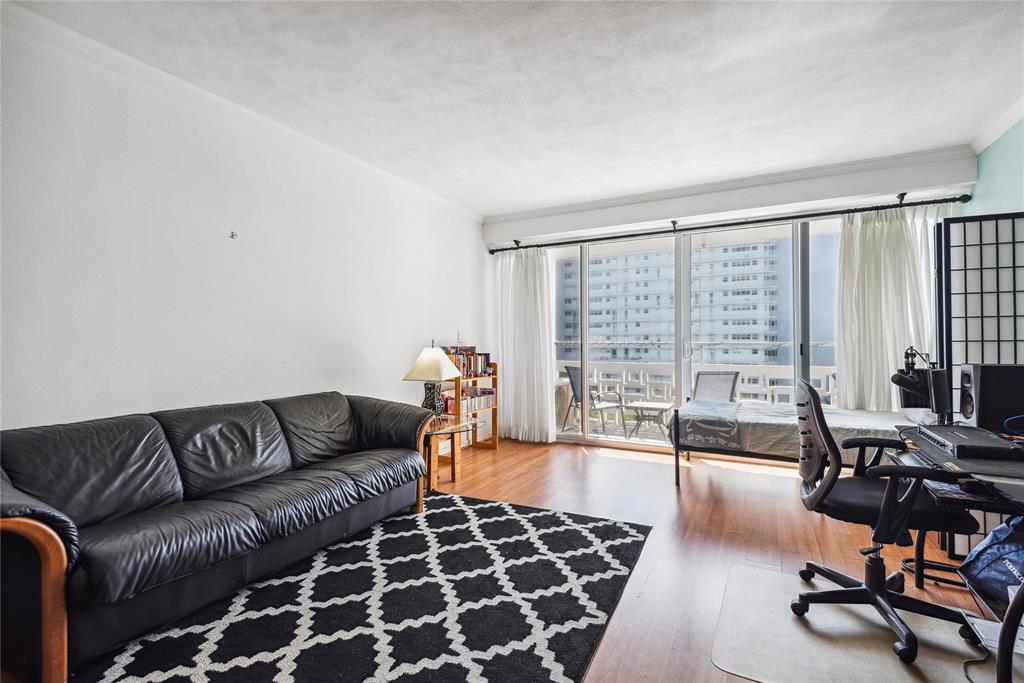 1900 South Ocean Drive, Unit 604 Fort Lauderdale, FL 33316 - Photo 2 of 33 a living room with furniture and a floor to ceiling window