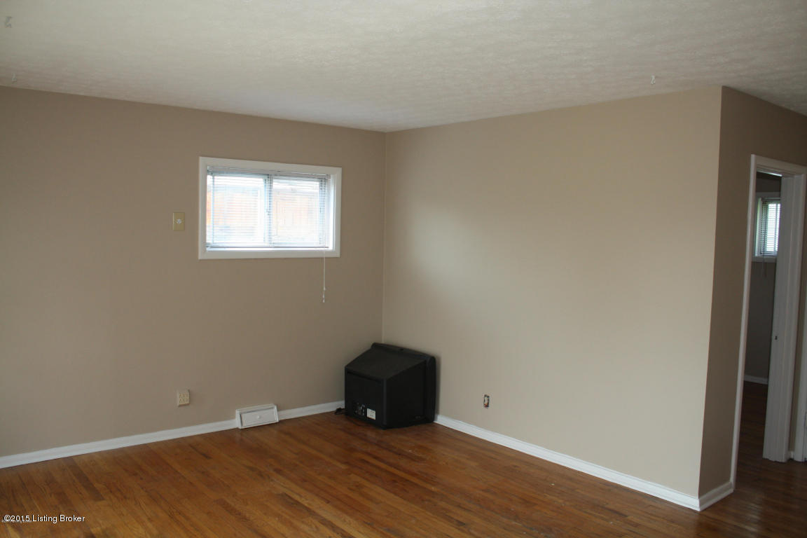 4815 Redstart Road Louisville, KY 40213 - Photo 4 of 27 Spacious living room with neutral paint and wood floors.
