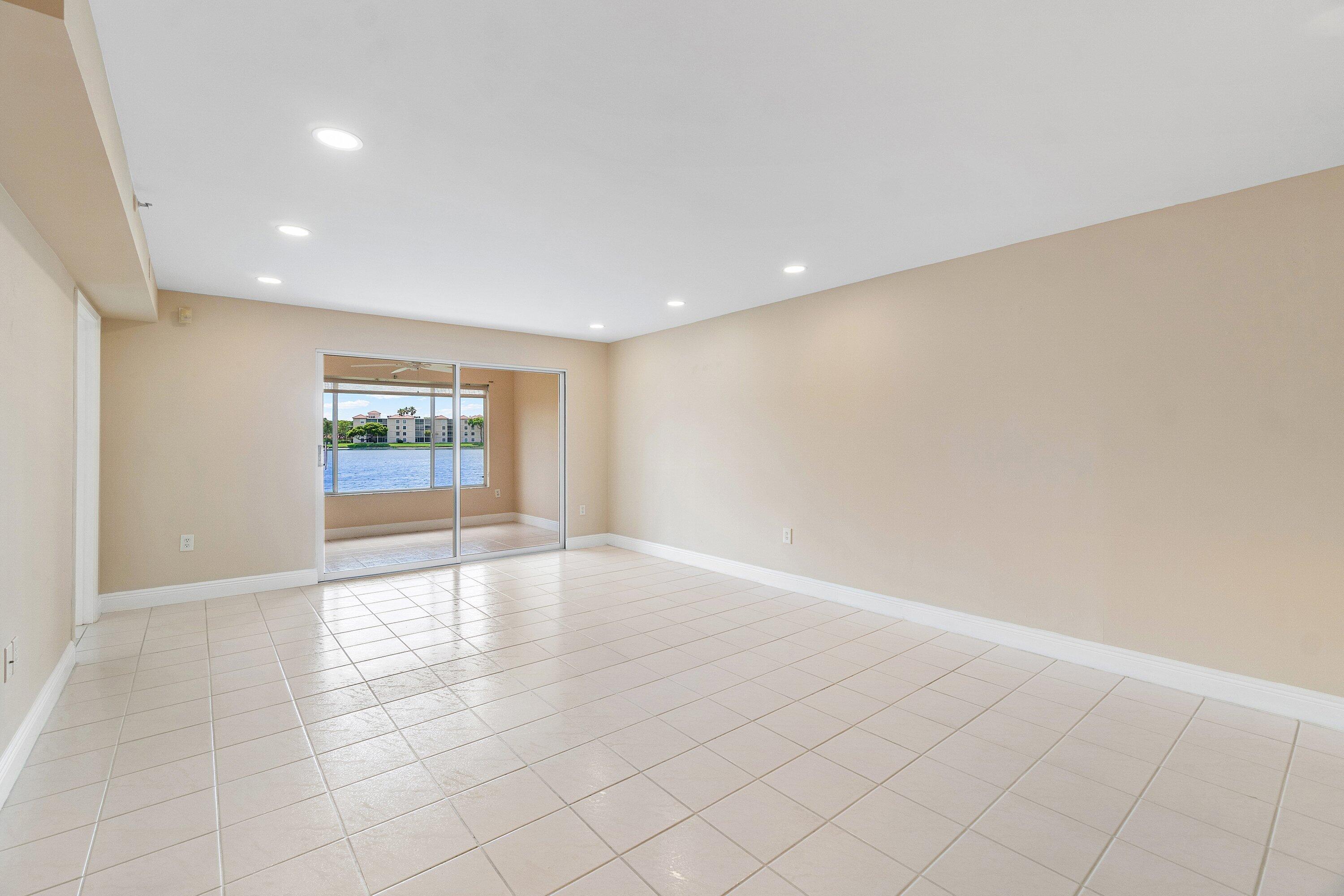 14096 Huntington Pointe Drive, Unit 106 Delray Beach, FL 33484 - Photo 12 of 47 an empty room with windows