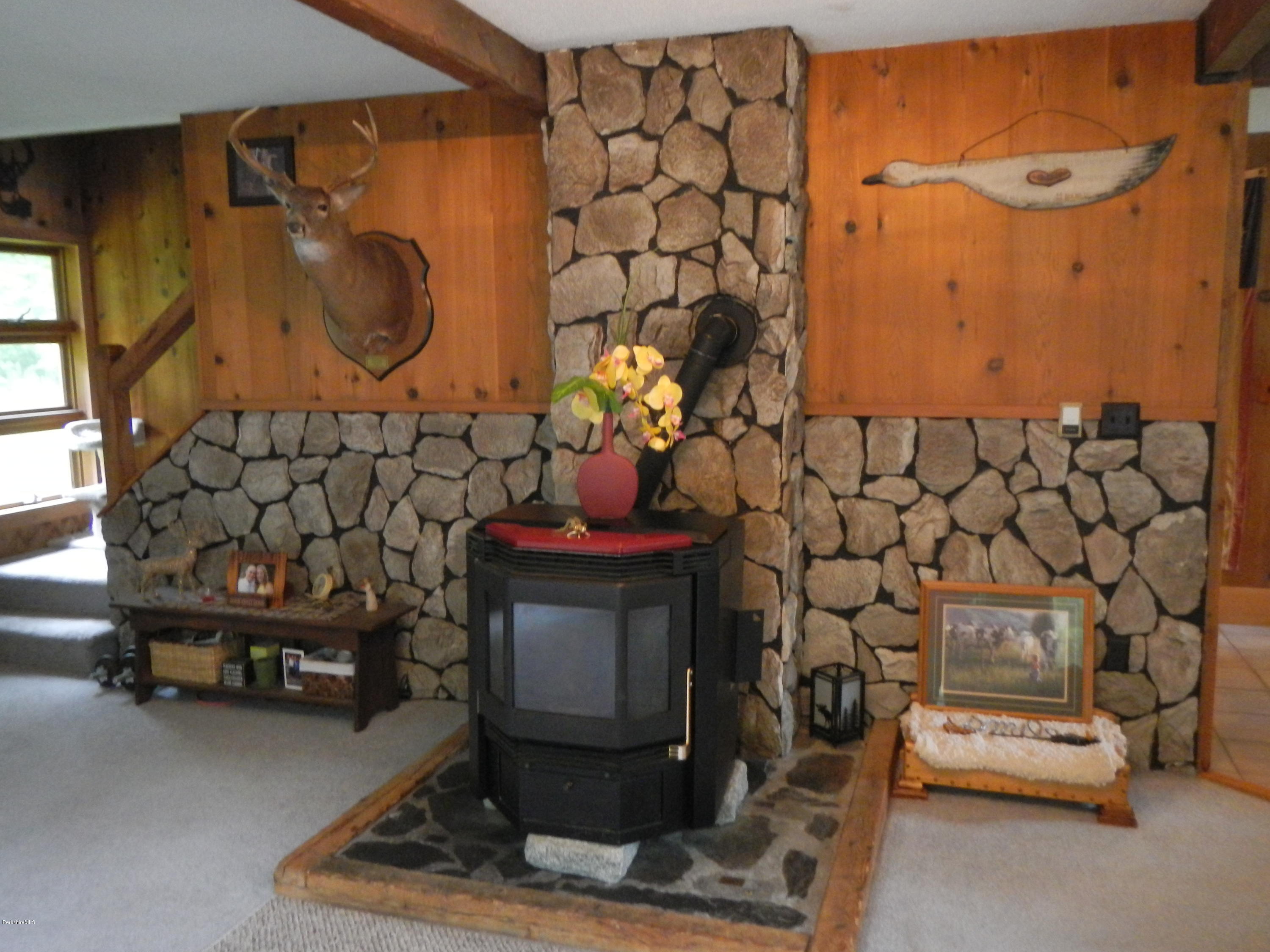 389 Sandmill Road Cheshire, MA 01225 - Photo 6 of 33 a room with a table and a fireplace