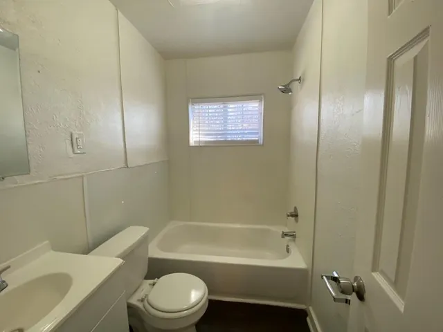 a bathroom with a bathtub toilet and sink