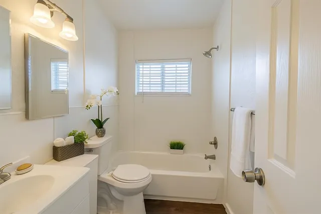 a bathroom with a sink toilet and shower