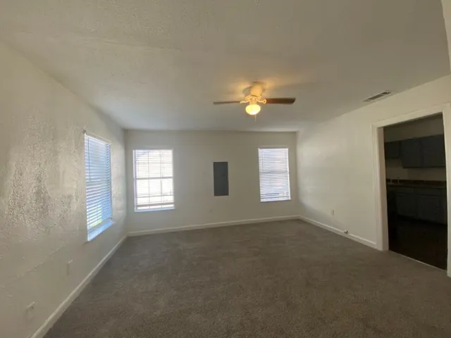 an empty room with windows and closet