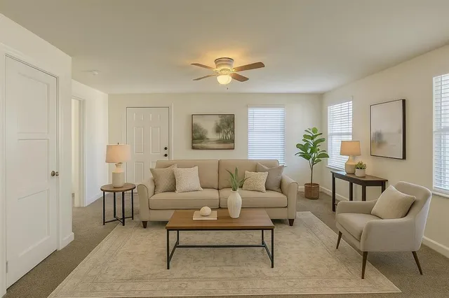 a living room with furniture and a chandelier