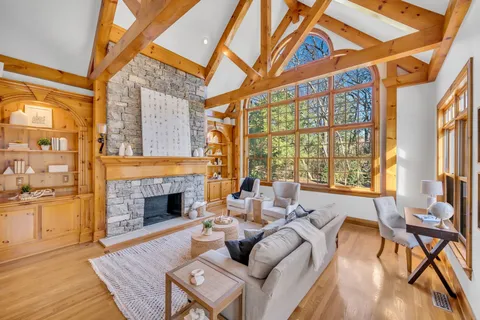 a living room with furniture a table and wooden floor
