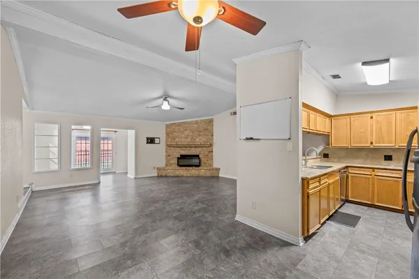 a large kitchen with cabinets and stainless steel appliances